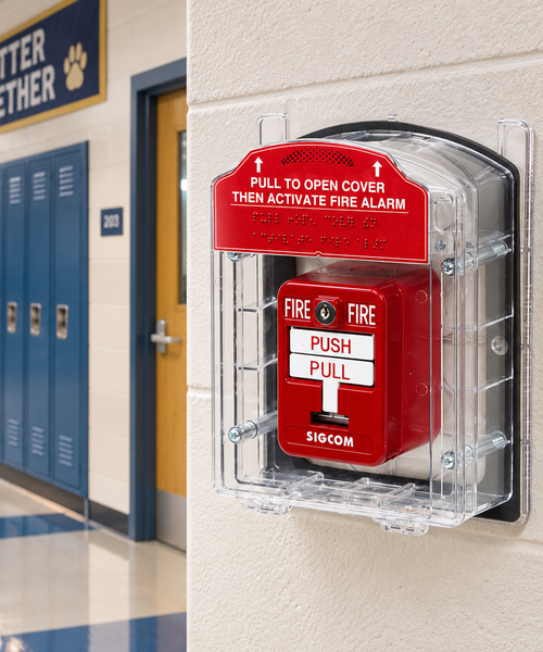 Fire alarm pull station mounted in school hallway